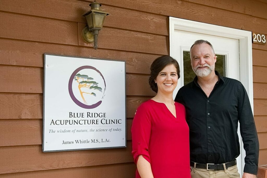 Trauma-informed acupuncture center owners, James and Tera Whittle, outside Blue Ridge Acupuncture Clinic in Asheville, NC.